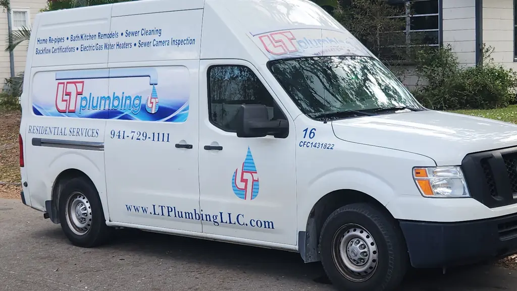 LT Plumbing service van number 16 with the company logo, phone number and license CFC1431822 painted on the door